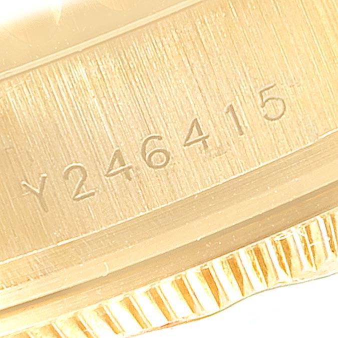 This close-up image shows the side engraving and part of the bezel of a Rolex Yacht-Master 169628 Women's Yellow Gold Mother of Pearl Dial 169628 Women's Yellow Gold Mother of Pearl Dial watch.