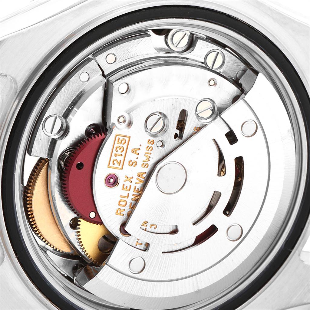 The image shows a close-up of the internal mechanical movement of a Rolex Yacht-Master 69623 Women's Steel and Gold (two tone) White Dial 69623 Women's Steel and Gold (two tone) White Dial watch, displaying gears and inscriptions.