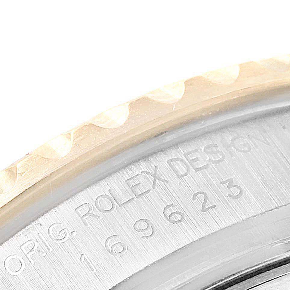 This image shows a close-up of the engraved bezel and case back of a Rolex Yacht-Master 69623 Women
s Steel and Gold (two tone) White Dial 69623 Women
s Steel and Gold (two tone) White Dial watch.