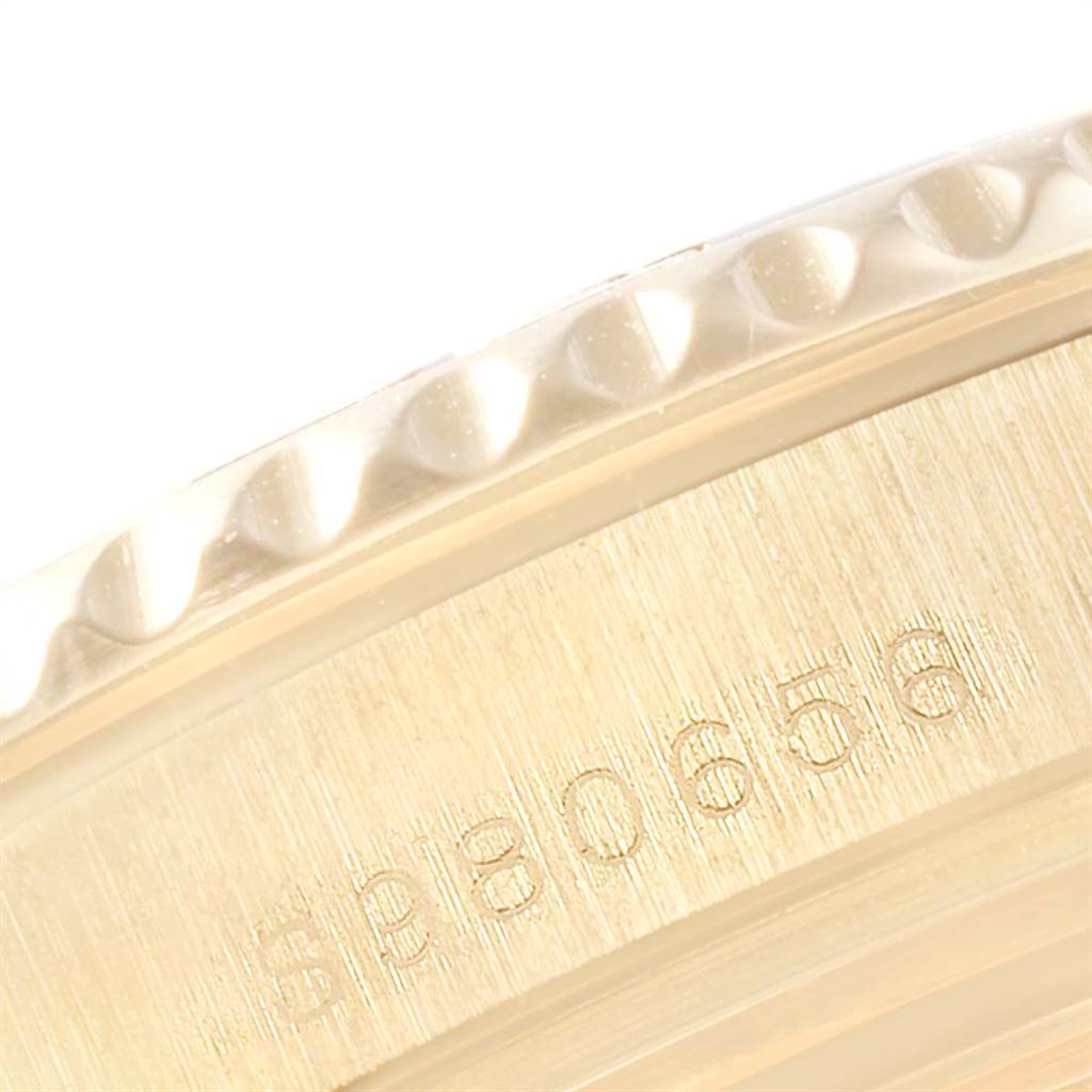 This close-up image shows the side of the bezel and case with the serial number for the Rolex Yacht-Master 68628 Yellow Gold White Dial 68628 Yellow Gold White Dial model.