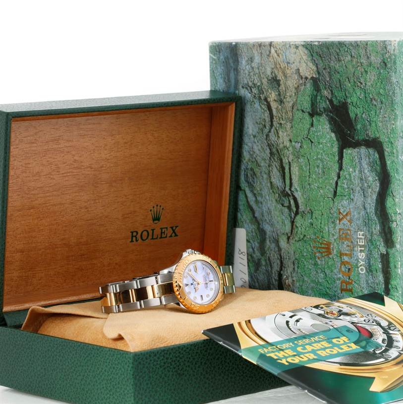 The Rolex Yacht-Master 169623 Women's Stainless Steel Mother of Pearl Dial 169623 Women's Stainless Steel Mother of Pearl Dial watch is shown in a partially opened green box with accompanying booklets visible.