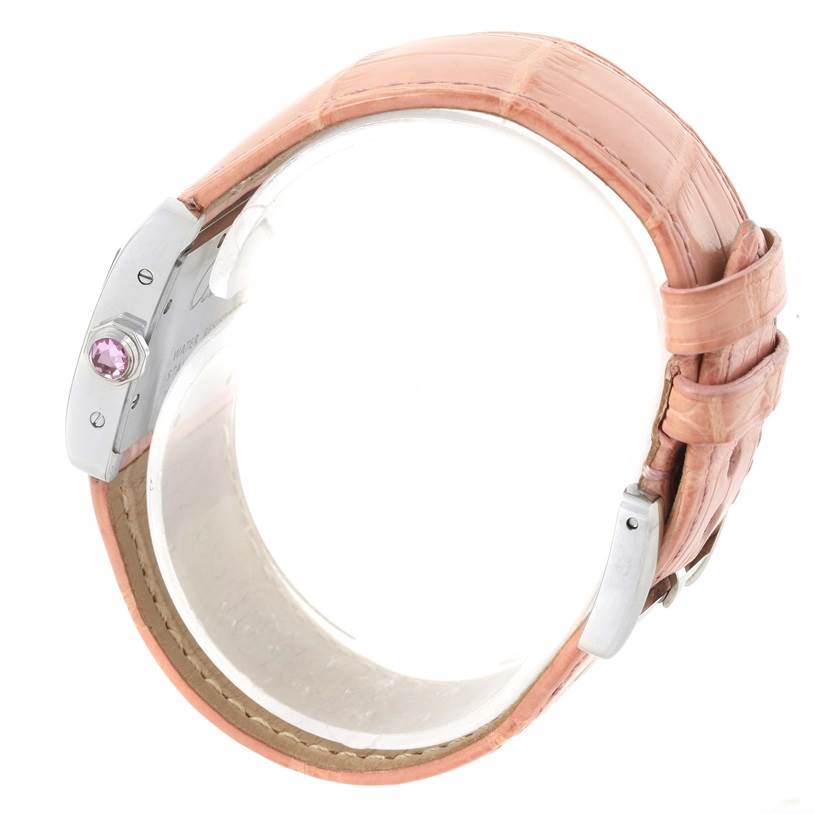 This image shows a side view of a Cartier Tank Divan W6301455 Women's Stainless Steel Mother of Pearl Dial W6301455 Women's Stainless Steel Mother of Pearl Dial watch, focusing on its pink strap and crown with a pink gem.