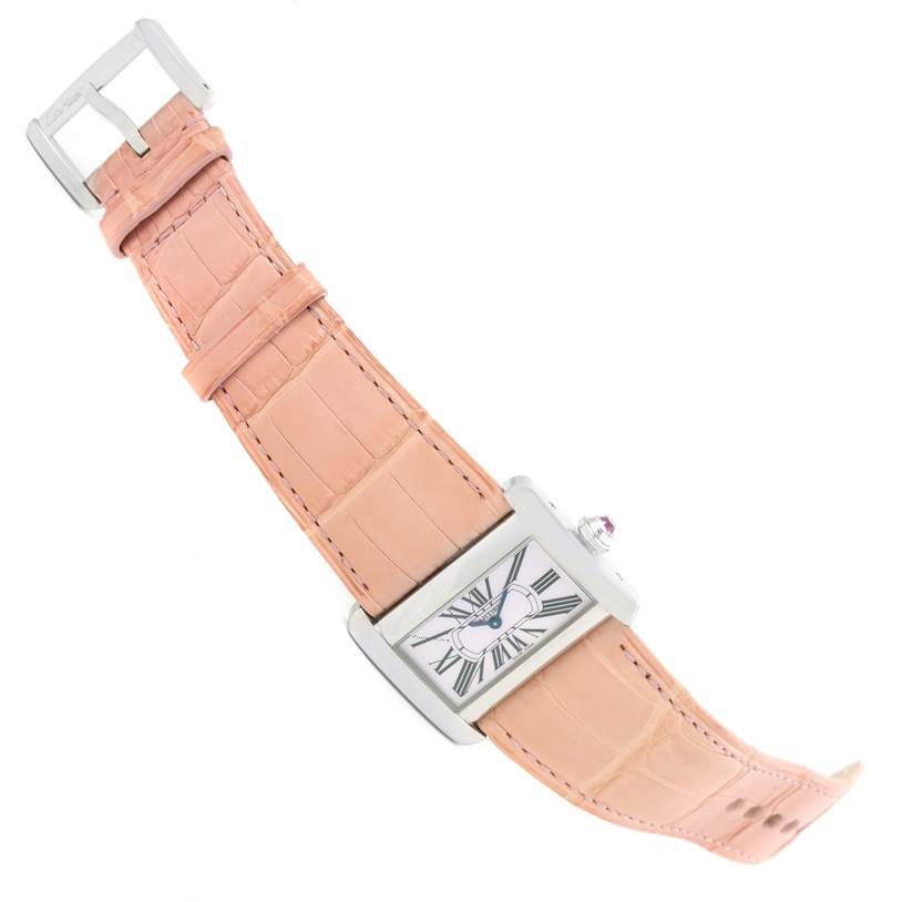 The Cartier Tank Divan W6301455 Women's Stainless Steel Mother of Pearl Dial W6301455 Women's Stainless Steel Mother of Pearl Dial watch is shown at an angle displaying its face, pink leather strap, and buckle.