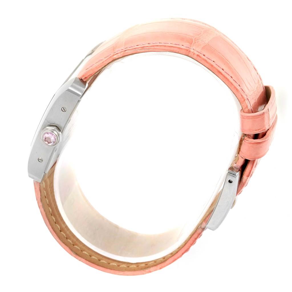 This image shows a side angle of the Cartier Tank Divan W6301455 Women's Stainless Steel Mother of Pearl Dial W6301455 Women's Stainless Steel Mother of Pearl Dial watch, highlighting the crown with a pink gemstone and a pink leather strap.