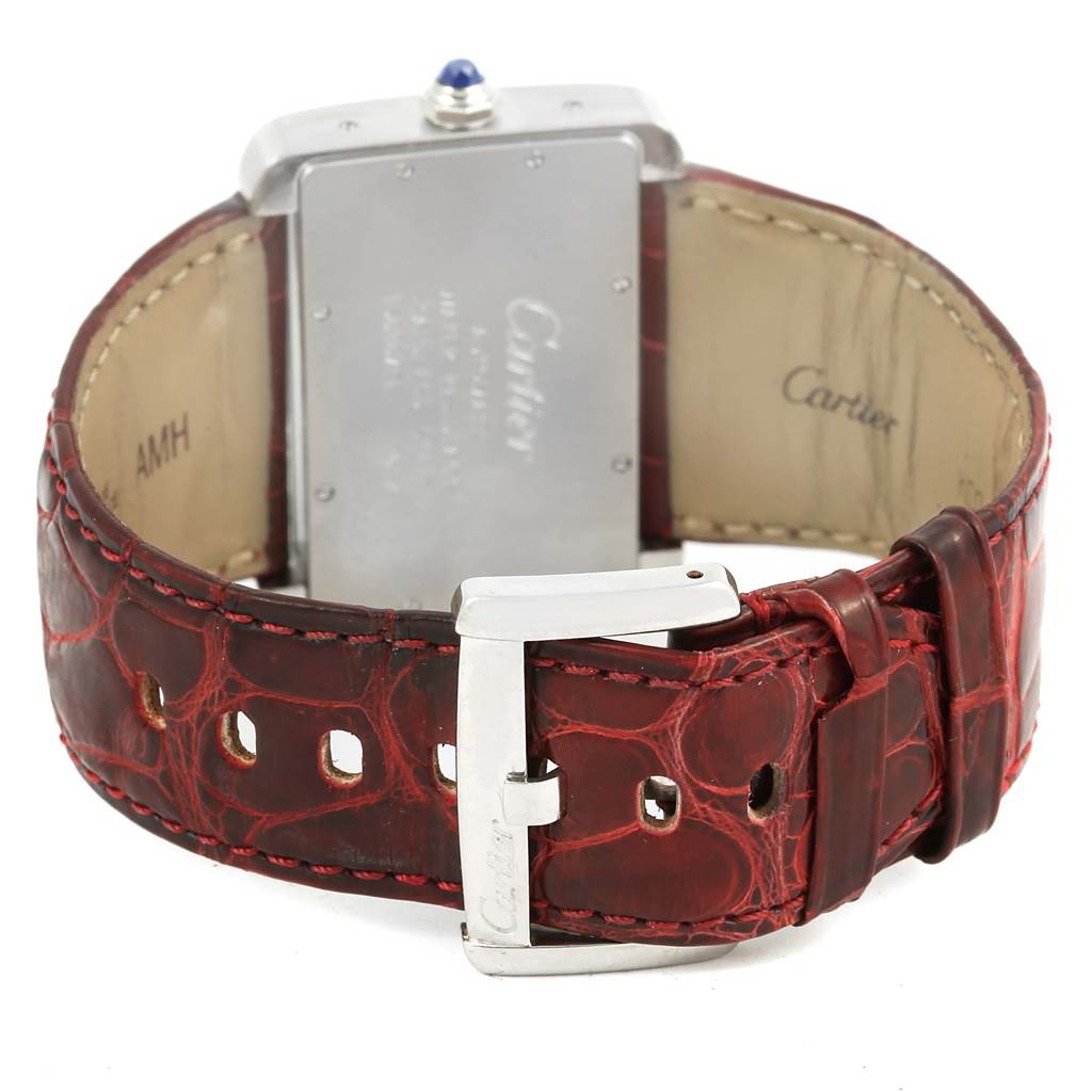 The image shows the back of the Cartier Tank Divan W6300755 Women's Stainless Steel Silver Dial W6300755 Women's Stainless Steel Silver Dial watch with a red leather strap and buckle.