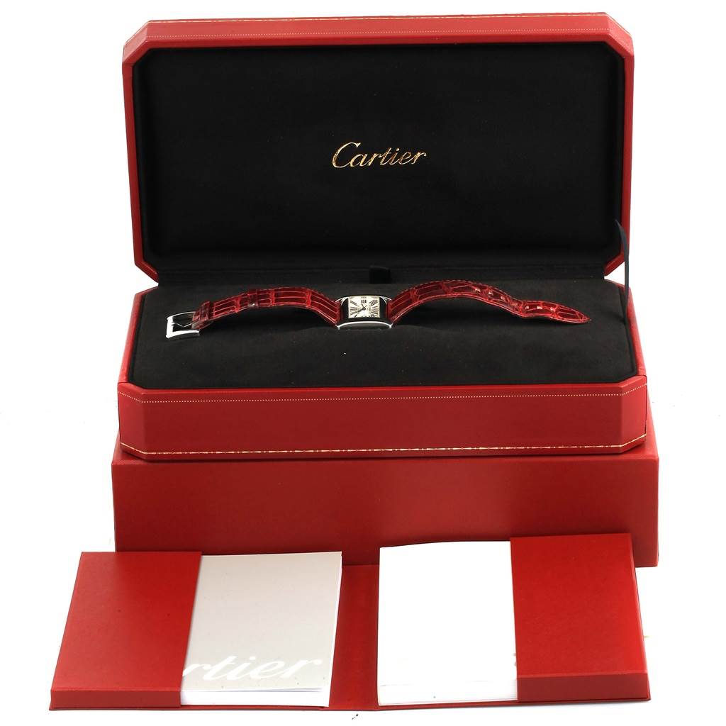 The image shows the Cartier Tank Divan W6300755 Women's Stainless Steel Silver Dial W6300755 Women's Stainless Steel Silver Dial watch at a horizontal angle inside a red presentation box with accompanying booklets.