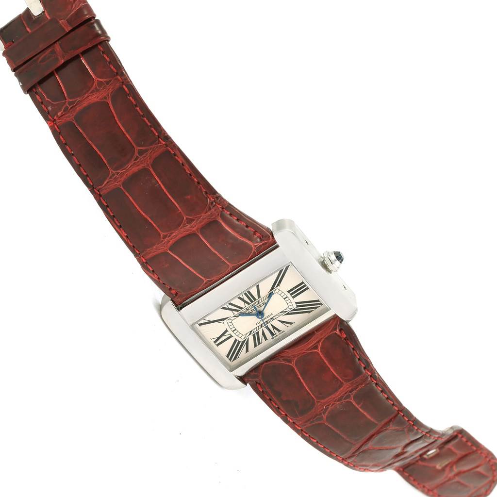 This image shows a top-down view of the Cartier Tank Divan W6300755 Women's Stainless Steel Silver Dial W6300755 Women's Stainless Steel Silver Dial watch, highlighting its face, case, and red leather strap.
