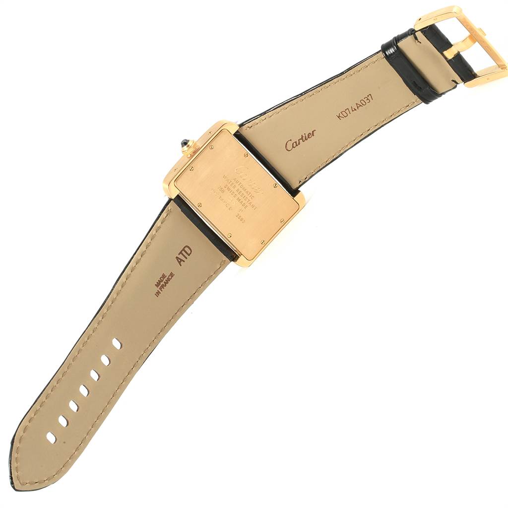 The Cartier Tank Divan W6300856 Women's Yellow Gold Silver Dial W6300856 Women's Yellow Gold Silver Dial watch is shown from the back, displaying its rectangular case and leather strap with buckle.
