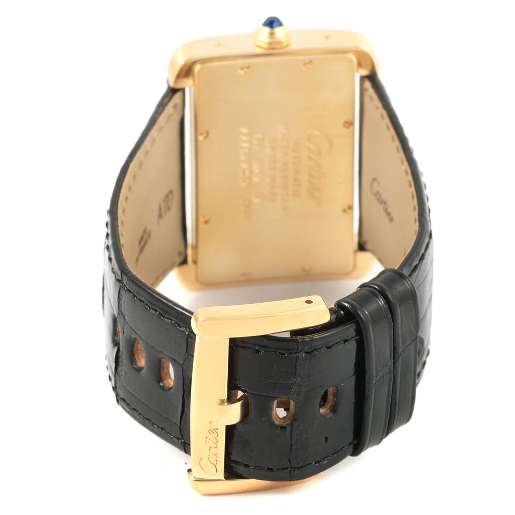 The image shows the back view of the Cartier Tank Divan W6300856 Women's Yellow Gold Silver Dial W6300856 Women's Yellow Gold Silver Dial watch, highlighting the case back and black leather strap with a gold buckle.