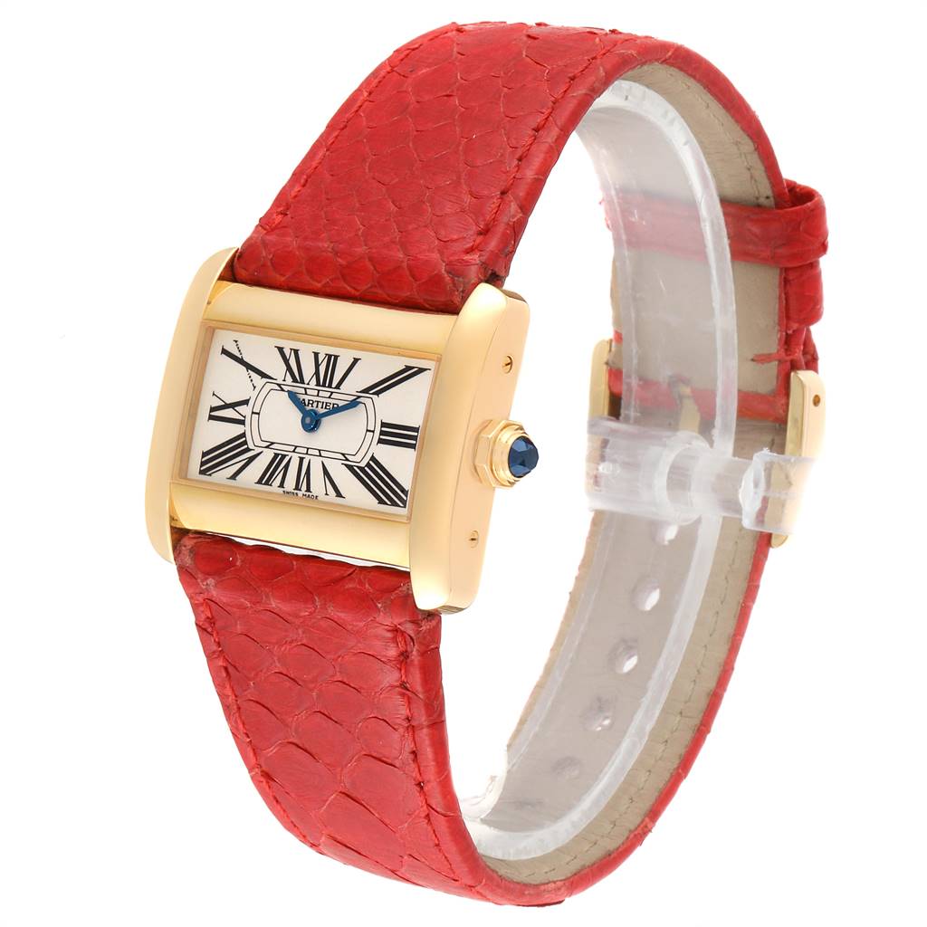 The Cartier Tank Divan W6300356 Women's Yellow Gold Silver Dial W6300356 Women's Yellow Gold Silver Dial watch is shown at a three-quarter angle, highlighting the face, red leather strap, and gold casing.