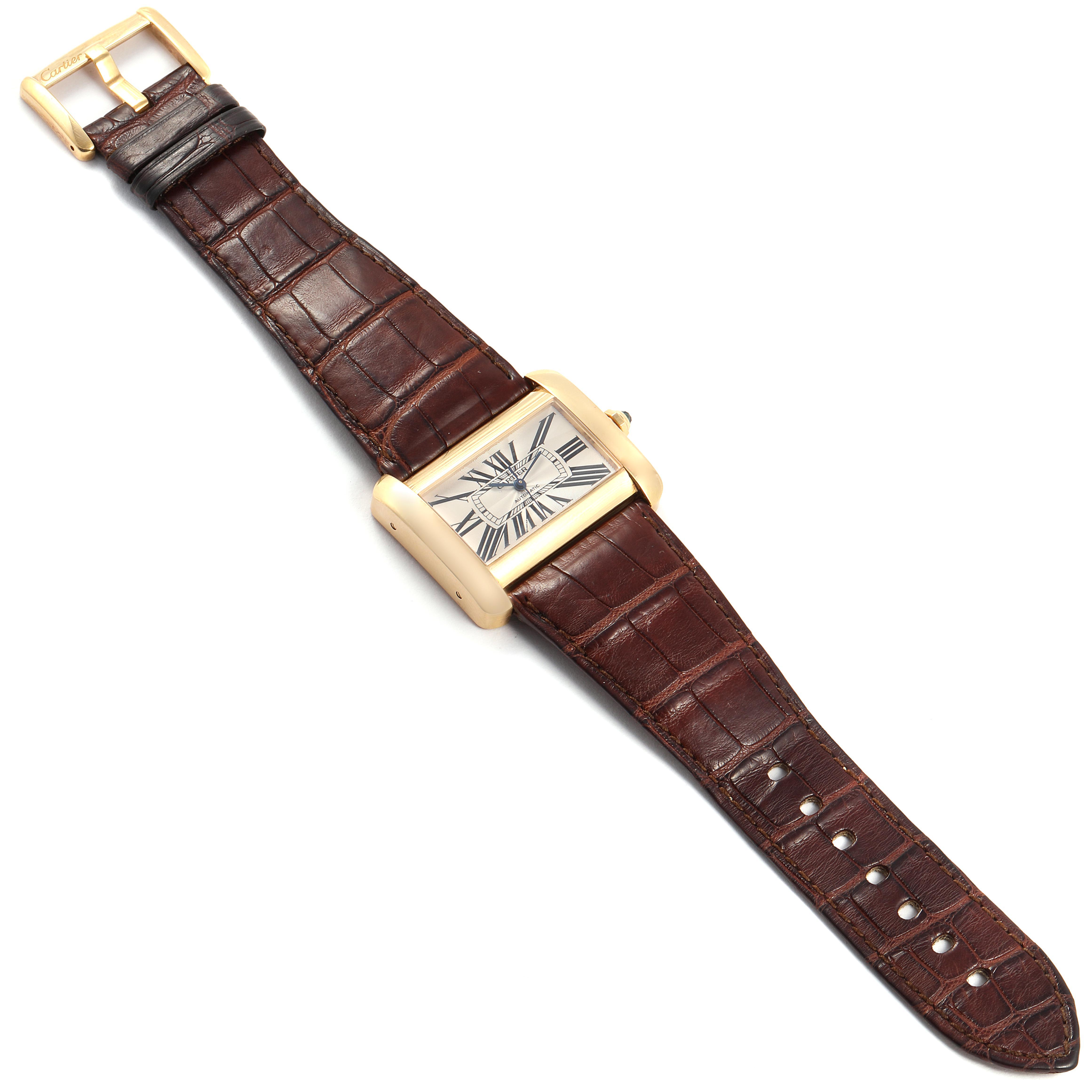 The Cartier Tank Divan W6300856‏ Women's Yellow Gold Silver Dial W6300856‏ Women's Yellow Gold Silver Dial watch is shown from a top-down angle, displaying the entire watch including the dial, case, and leather strap.