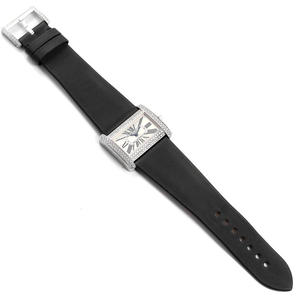 The Cartier Tank Divan WA301271 Women's White Gold Silver Dial WA301271 Women's White Gold Silver Dial watch is shown from a top-down angle, displaying its rectangular face, black strap, and buckle.