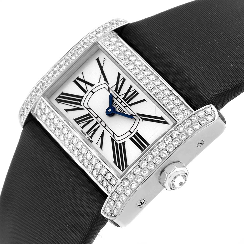 This Tank Divan model by Cartier is shown at an angled side view, highlighting its diamond-studded bezel and black strap.