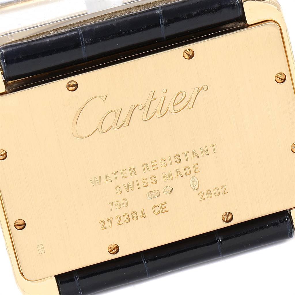 The image shows the back case of a Cartier Tank Divan WA301170‏ Women's Yellow Gold Silver Dial WA301170‏ Women's Yellow Gold Silver Dial watch, featuring engravings and part of the strap attachment.
