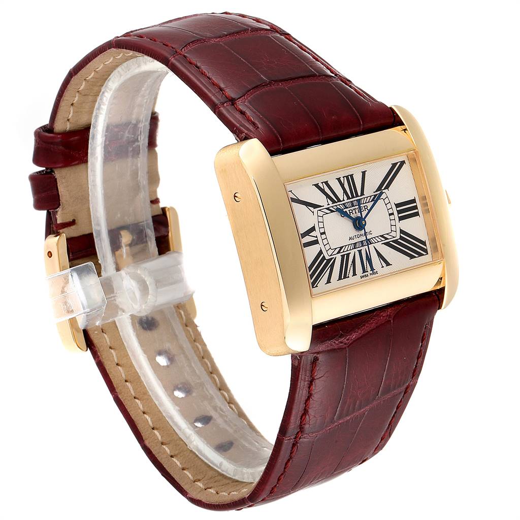 The image showcases a Cartier Tank Divan W6300856 Women's Yellow Gold Silver Dial W6300856 Women's Yellow Gold Silver Dial watch from a side angle, highlighting its gold case, Roman numeral dial, and burgundy leather strap.