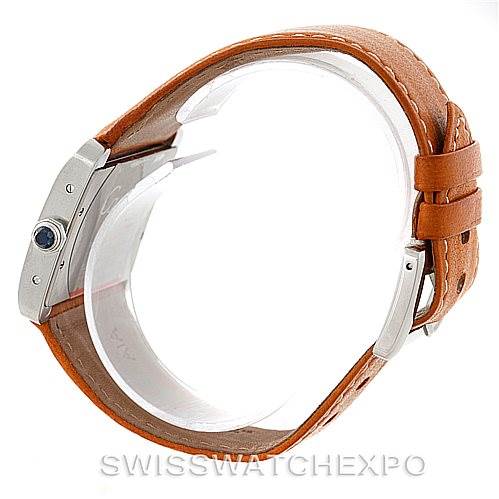 The image shows the side and part of the back of the Cartier Tank Divan W6300655 Men's Stainless Steel Silver Dial W6300655 Men's Stainless Steel Silver Dial watch, highlighting its brown leather strap and silver casing.