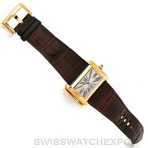 This image shows a Cartier Tank Divan W6300856 Yellow Gold Silver Dial W6300856 Yellow Gold Silver Dial watch from an angled top view, highlighting its face, brown strap, and gold buckle.