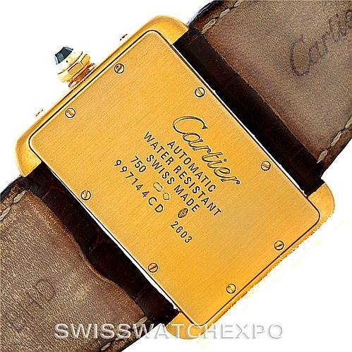 The image shows the back case of a Cartier Tank Divan W6300856 Yellow Gold Silver Dial W6300856 Yellow Gold Silver Dial watch, highlighting its engravings and leather strap.