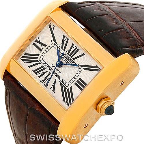 This image shows a Cartier Tank Divan W6300856 Yellow Gold Silver Dial W6300856 Yellow Gold Silver Dial watch at an angle highlighting its face, case, crown, and part of the leather strap.