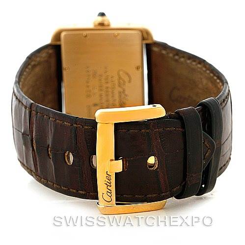 This image shows the back view of a Cartier Tank Divan W6300856 Yellow Gold Silver Dial W6300856 Yellow Gold Silver Dial watch, focusing on its gold buckle and brown leather strap.