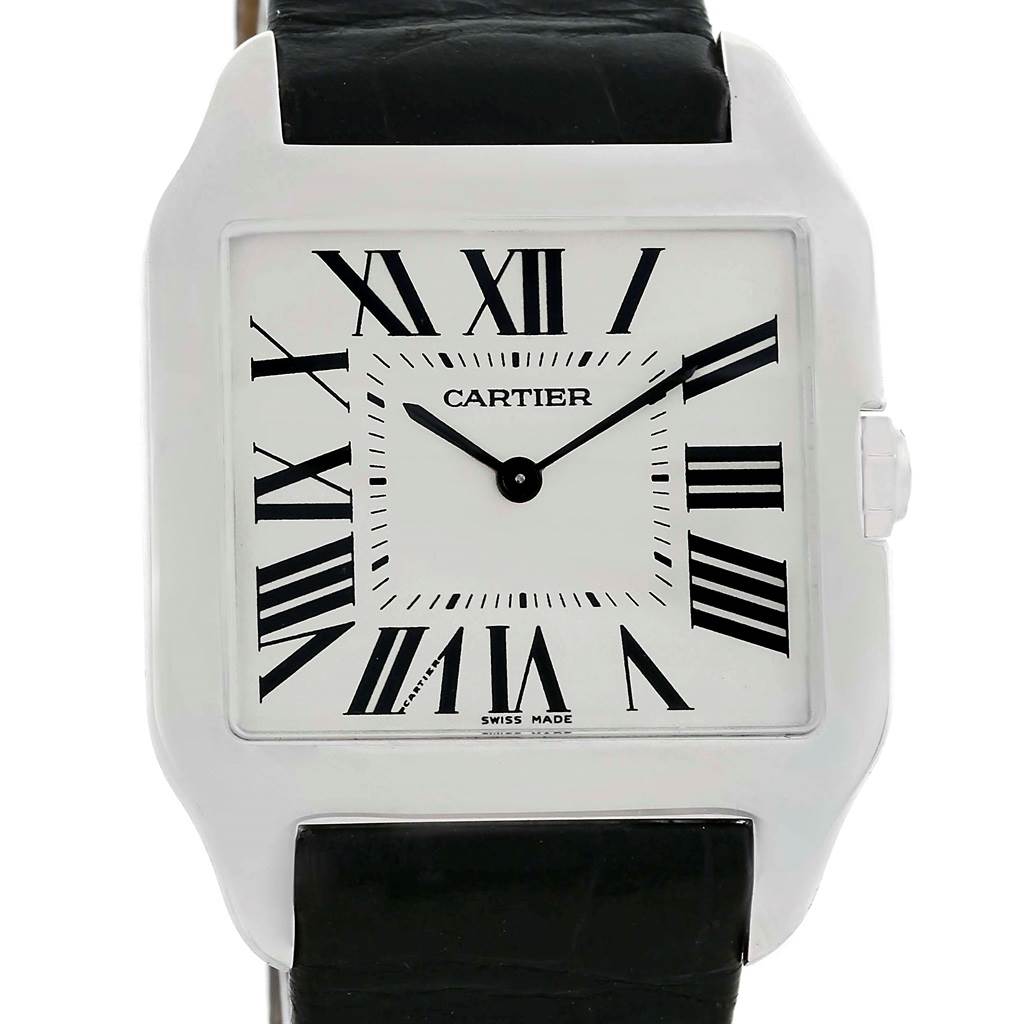 The image shows a front view of the Santos Dumont watch by Cartier, featuring a square dial with Roman numerals and a black leather strap.
