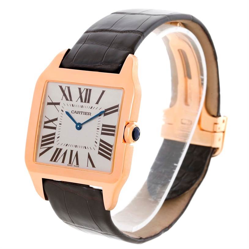 The image shows a Cartier Santos Dumont W2006951 Men
s Rose Gold Silver Dial W2006951 Men
s Rose Gold Silver Dial watch from a 3/4 angle, highlighting its face, bezel, crown, and leather strap.