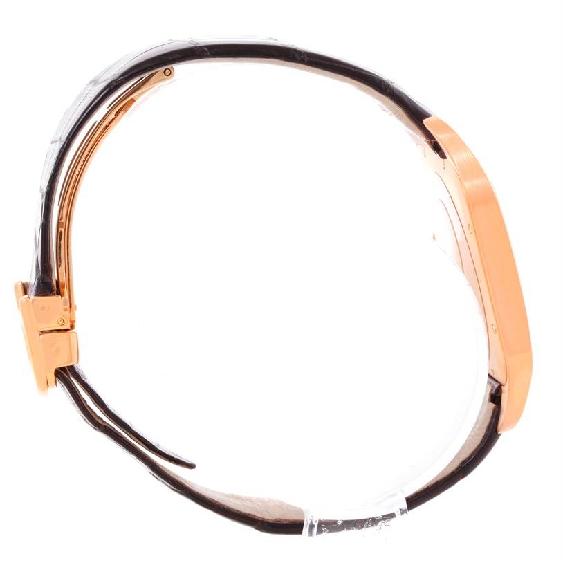 The image shows a side view of the Santos Dumont watch by Cartier, highlighting its strap, buckle, and case.