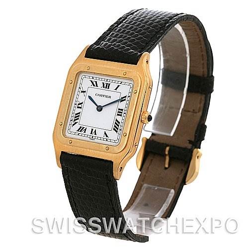 This image shows an angled view of the Cartier Santos Dumont Yellow Gold White Dial Yellow Gold White Dial watch, highlighting its rectangular face, gold-tone case, and black leather strap.