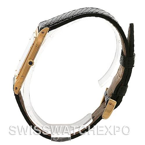 The image shows a side view of a Cartier Santos Dumont Yellow Gold White Dial Yellow Gold White Dial watch, highlighting its strap and side casing.