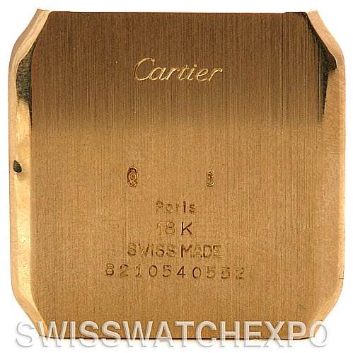 The image shows the backplate of a Cartier Santos Dumont Yellow Gold White Dial Yellow Gold White Dial watch, showcasing engravings and material details.