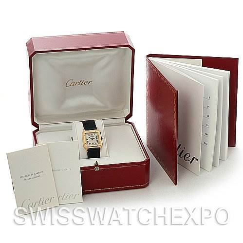 The image shows a Cartier Santos Dumont Yellow Gold White Dial Yellow Gold White Dial watch in its open box along with booklets and a red leather document holder.
