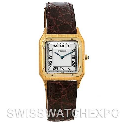 The image shows a front view of a Cartier Santos Dumont Yellow Gold White Dial Yellow Gold White Dial watch with a gold case, white dial, Roman numerals, and brown leather strap.