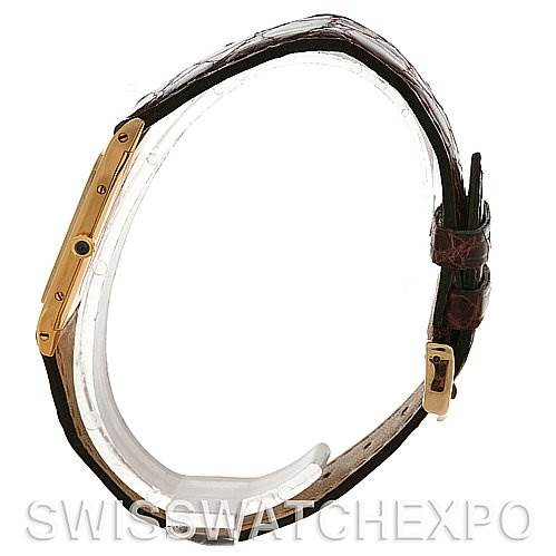 The image shows a side view of the Cartier Santos Dumont Yellow Gold White Dial Yellow Gold White Dial watch, highlighting its thin profile, leather strap, and buckle.