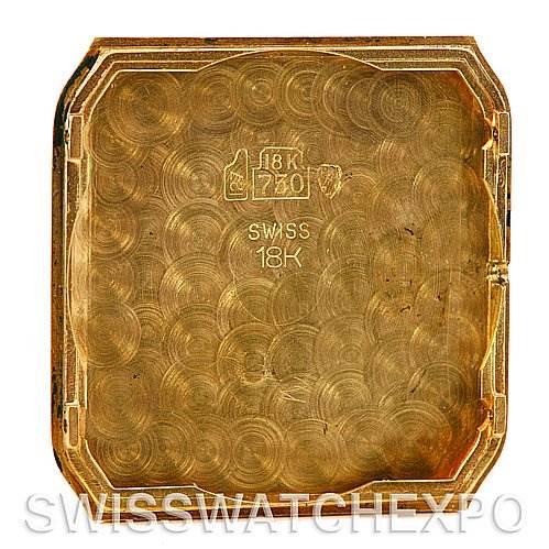 This image shows the inside of the case back of a Cartier Santos Dumont Yellow Gold White Dial Yellow Gold White Dial watch, marked "Swiss 18K."