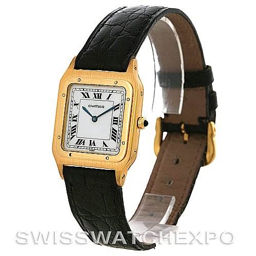 The image shows a Cartier Santos Dumont Men's Yellow Gold White Dial Men's Yellow Gold White Dial watch at a slight angle, displaying its rectangular dial, Roman numerals, and black leather strap.