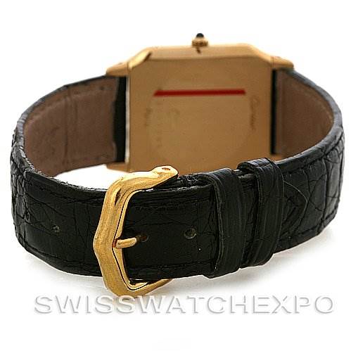 This image shows the back of the Cartier Santos Dumont Men's Yellow Gold White Dial Men's Yellow Gold White Dial watch, including its black leather strap and gold buckle.