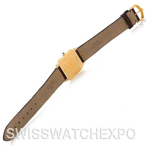 The image shows the backside of a Cartier Santos Dumont Men's Yellow Gold White Dial Men's Yellow Gold White Dial watch, displaying the strap, buckle, and caseback from an angled top view.