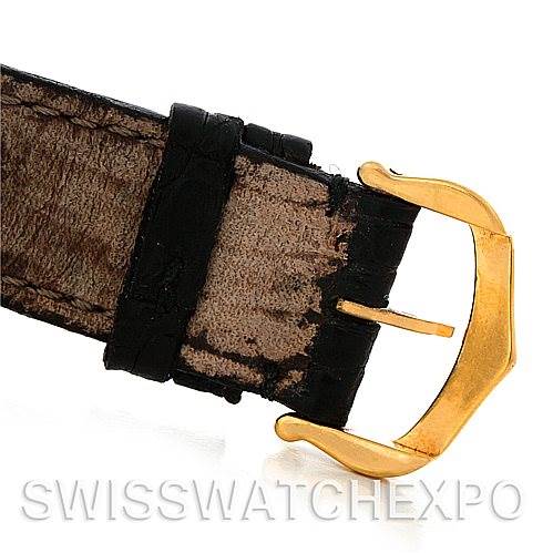 This image shows the buckle end of a Santos Dumont model strap by Cartier, featuring a gold buckle and a brown leather strap.
