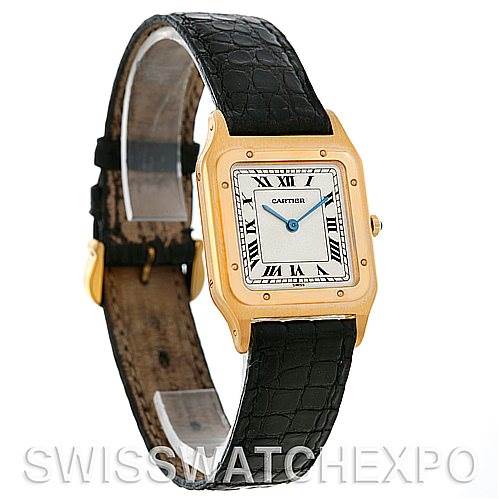 This image shows a front angle view of a Cartier Santos Dumont Men's Yellow Gold White Dial Men's Yellow Gold White Dial watch with a gold case and a black leather strap.