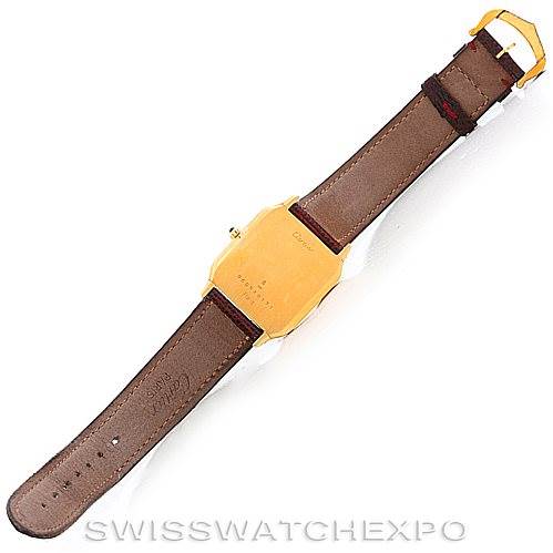 The image shows the back view of the Cartier Santos Dumont Men's Yellow Gold White Dial Men's Yellow Gold White Dial watch, highlighting its leather strap and gold caseback.