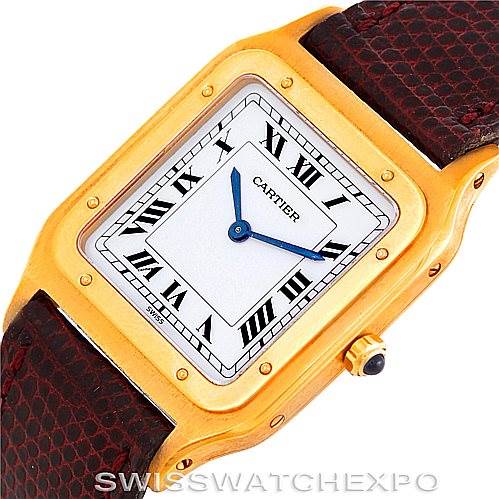 The image shows a close-up, top-down view of a Cartier Santos Dumont Men's Yellow Gold White Dial Men's Yellow Gold White Dial watch, highlighting the face, case, and part of the strap.
