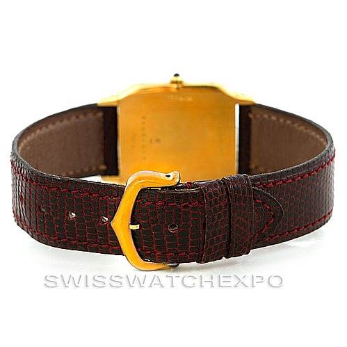 The image shows the back of the Cartier Santos Dumont Men's Yellow Gold White Dial Men's Yellow Gold White Dial watch, including its leather strap and gold buckle.