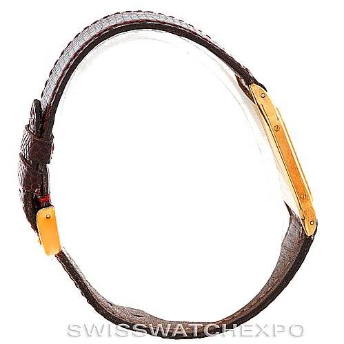 This image shows a side view of a Cartier Santos Dumont Men's Yellow Gold White Dial Men's Yellow Gold White Dial watch, highlighting its yellow gold case and brown leather strap.