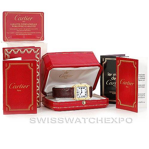 The image shows a Cartier Santos Dumont Men's Yellow Gold White Dial Men's Yellow Gold White Dial watch with a brown leather strap, red presentation box, warranty card, and instruction manuals.