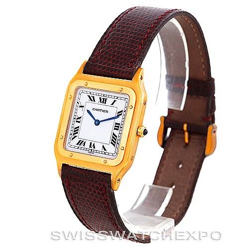 The image shows a Cartier Santos Dumont Men's Yellow Gold White Dial Men's Yellow Gold White Dial watch at a three-quarter angle, highlighting the watch face, case, and leather strap.