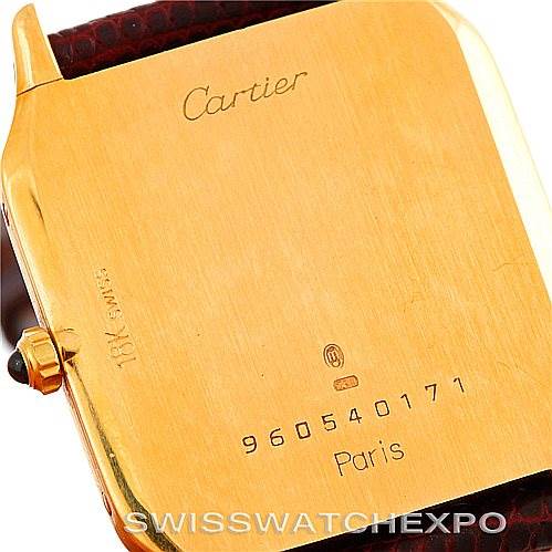 The image shows the back case of a Santos Dumont Cartier watch, displaying its engravings and serial number.