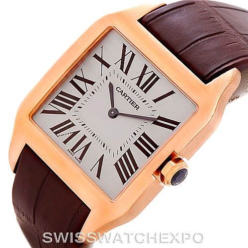 The Cartier Santos Dumont W2006951 Men's Rose Gold Silver Dial W2006951 Men's Rose Gold Silver Dial watch is shown at a three-quarter angle, displaying the face, case, and part of the brown leather strap.
