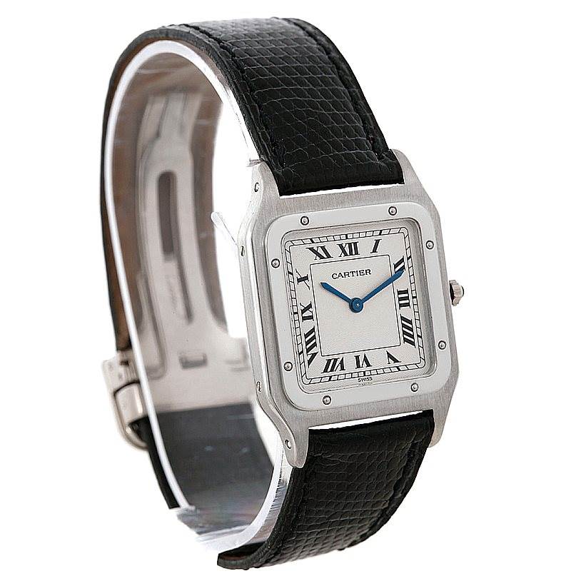 The image shows a front angle of the Santos Dumont model by Cartier, highlighting its square face, Roman numerals, and black leather strap.