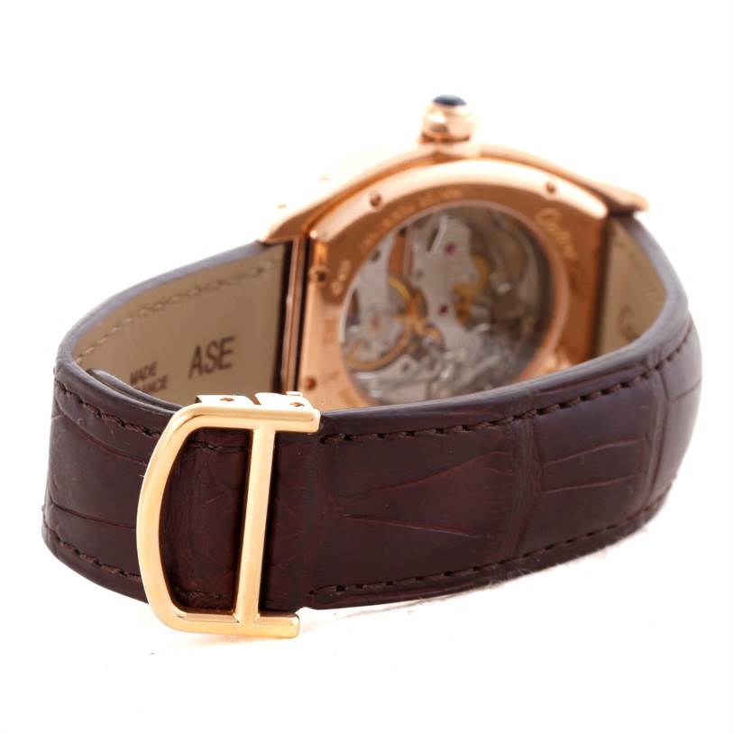 The image shows the back side of the Cartier Tortue W1543651 Men's Rose Gold Silver Dial W1543651 Men's Rose Gold Silver Dial watch, featuring a leather strap and visible movement through the transparent case back.