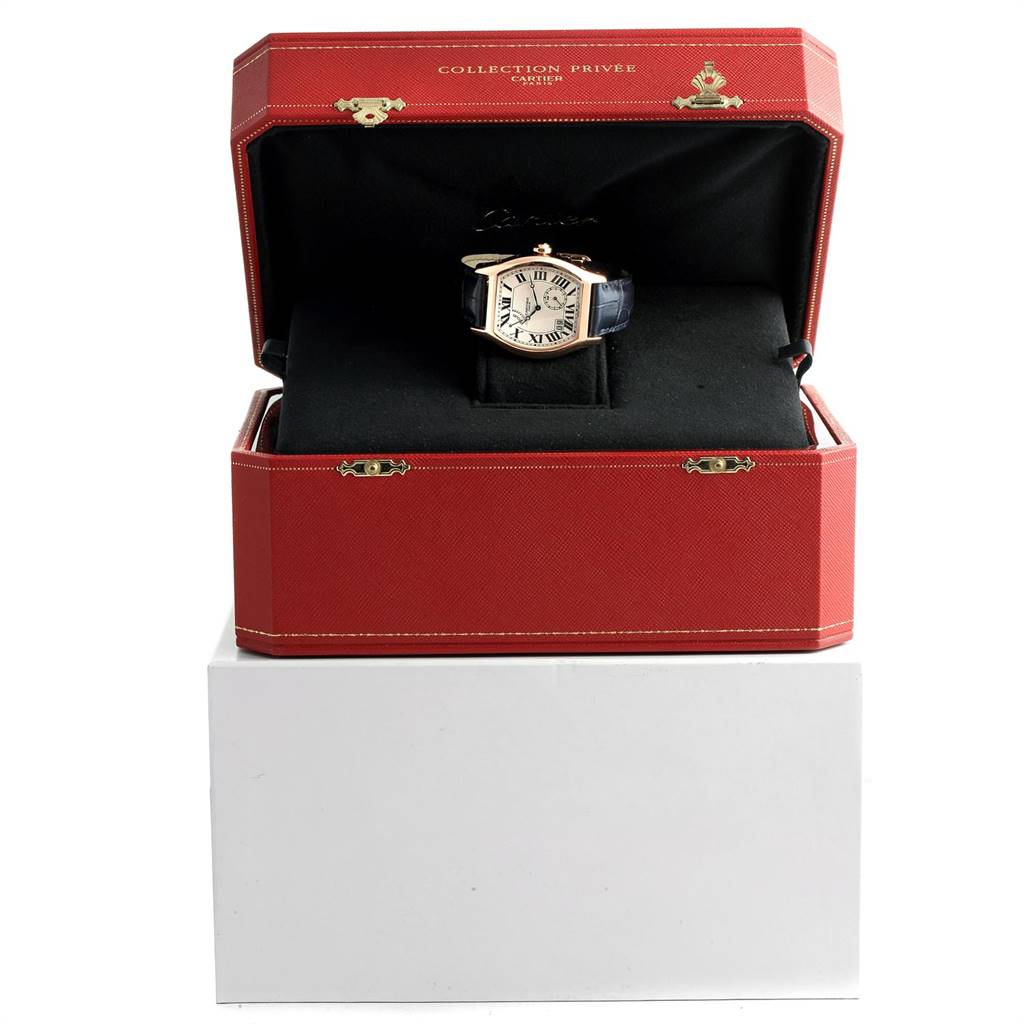 The Cartier Tortue W1545851 Men's Rose Gold Silver Dial W1545851 Men's Rose Gold Silver Dial watch is showcased in an open red box, frontal view, highlighting the watch face and leather strap.
